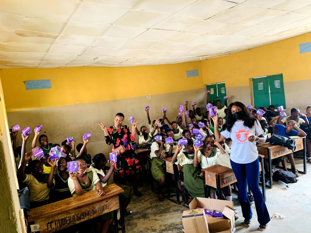 QUEENTREPRENEUR WOMEN'S FOUNDATION PRESIDENT SHARING SANITARY TOWELS TO YOUNG GIRLS AT JUNIOR SECONDARY SCHOOL IN ABUJA